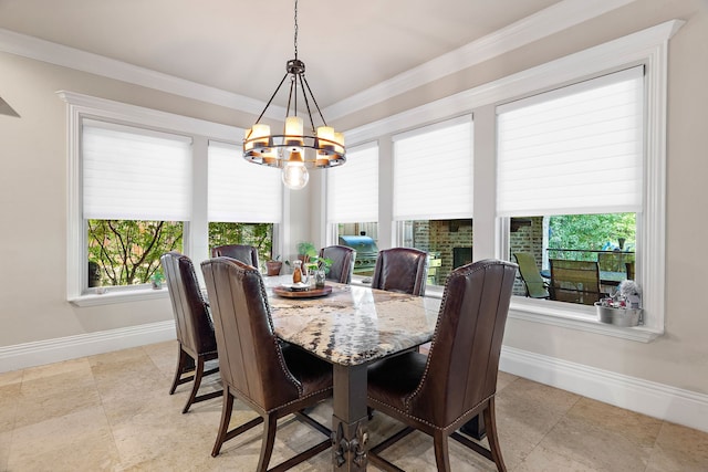 dining area with crown molding and an inviting chandelier