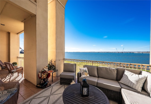 balcony featuring a water view and an outdoor living space