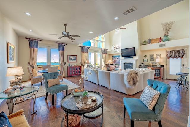 living room featuring ceiling fan and dark wood-type flooring