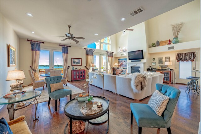 living room featuring dark wood-type flooring, ceiling fan, and french doors