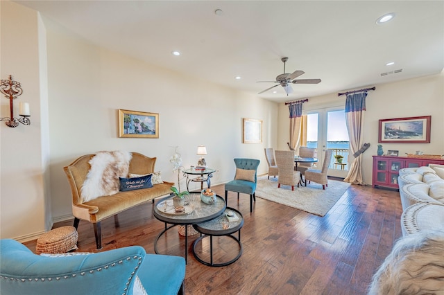 living room with ceiling fan and dark hardwood / wood-style floors