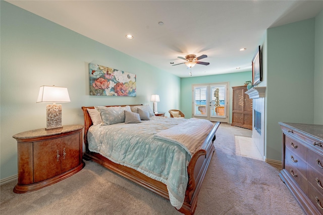 bedroom featuring ceiling fan, access to exterior, and light carpet