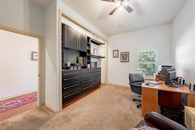 home office featuring ceiling fan and light colored carpet