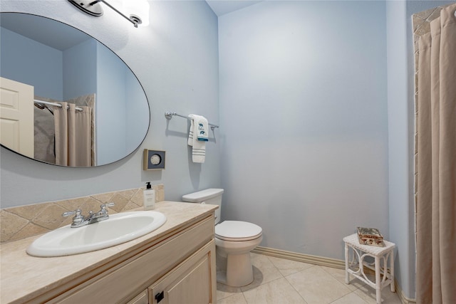 bathroom featuring toilet, vanity, a shower with shower curtain, and tile patterned flooring