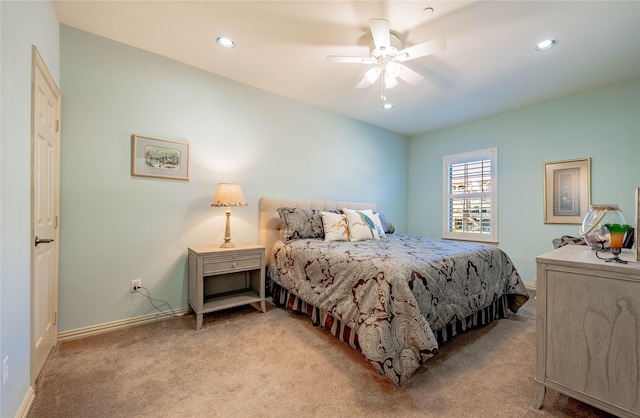 bedroom featuring light carpet and ceiling fan