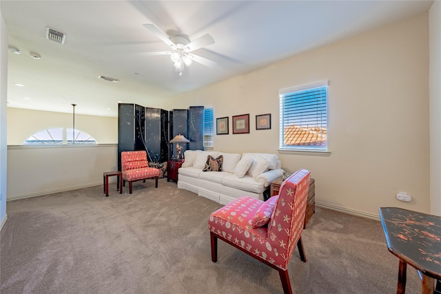 carpeted living room featuring ceiling fan and a healthy amount of sunlight