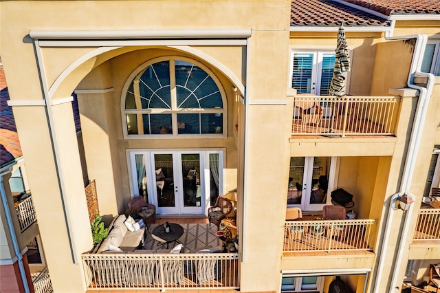 rear view of property featuring french doors