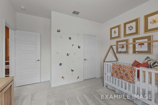 bedroom with light carpet and a nursery area