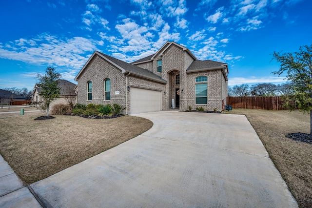 view of front of house featuring a garage and a front lawn