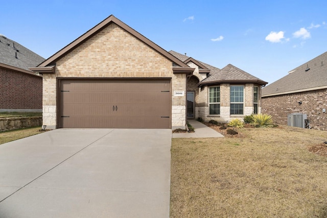 view of front facade featuring a garage, central AC, and a front lawn