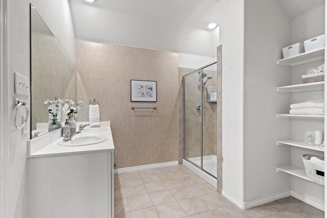 bathroom featuring tile patterned floors, vanity, and a shower with shower door