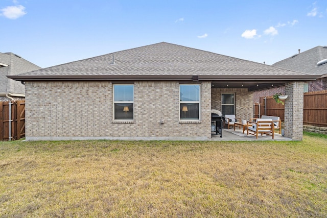 rear view of property featuring outdoor lounge area, a yard, and a patio area