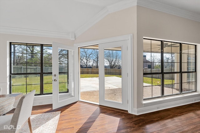 entryway featuring crown molding, a healthy amount of sunlight, lofted ceiling, and hardwood / wood-style floors