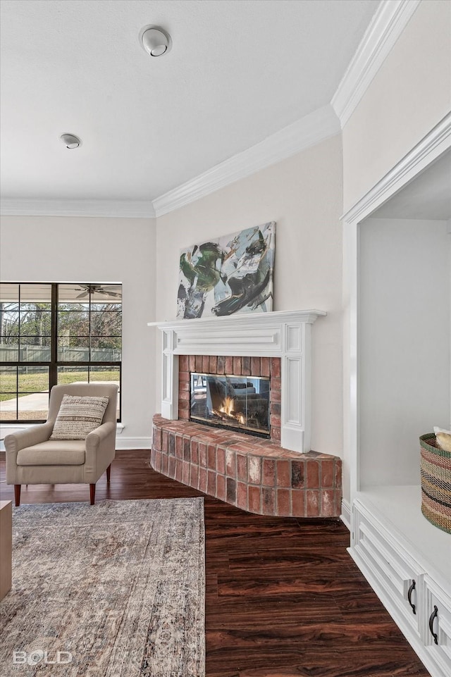 living room featuring ornamental molding, dark hardwood / wood-style flooring, and a brick fireplace