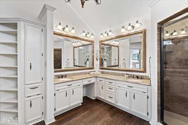 bathroom featuring hardwood / wood-style flooring, lofted ceiling, vanity, and a shower with door