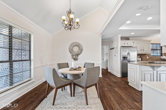 dining room featuring a notable chandelier, dark hardwood / wood-style floors, and crown molding