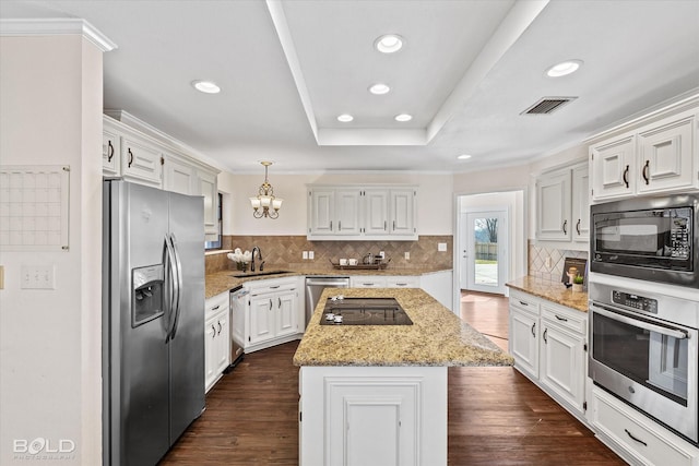 kitchen featuring white cabinetry, a center island, sink, and black appliances