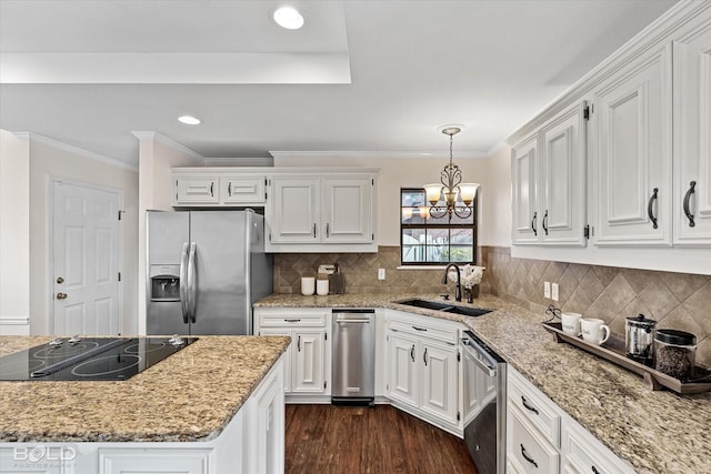 kitchen with pendant lighting, sink, dark wood-type flooring, white cabinetry, and stainless steel appliances