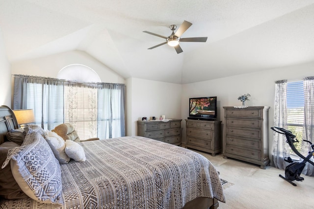 carpeted bedroom with ceiling fan and lofted ceiling