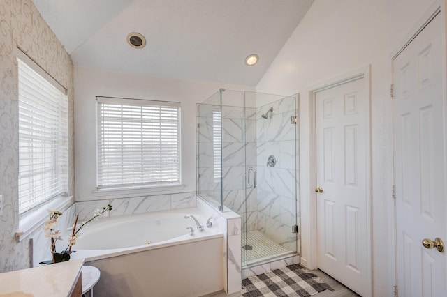 bathroom with vanity, separate shower and tub, and vaulted ceiling