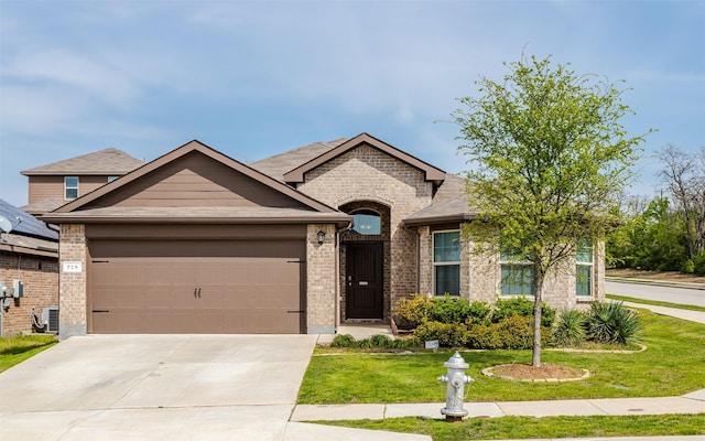 view of front of property featuring a garage, central air condition unit, and a front yard