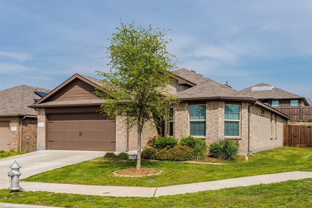 view of front of home featuring a front yard and a garage