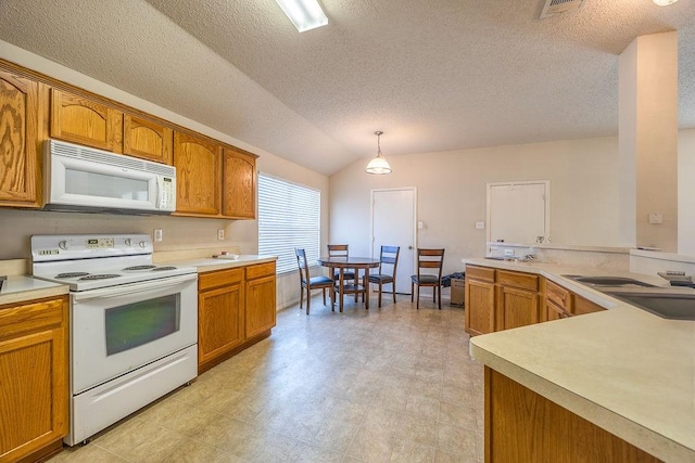 kitchen with pendant lighting, lofted ceiling, white appliances, sink, and a textured ceiling