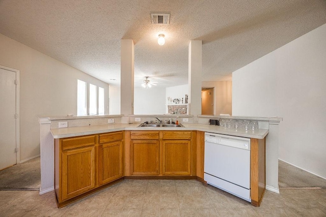 kitchen featuring kitchen peninsula, a textured ceiling, white dishwasher, ceiling fan, and sink