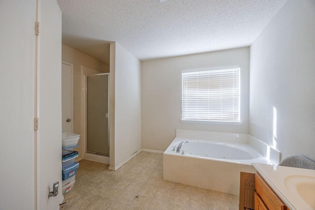 bathroom featuring vanity, a textured ceiling, and shower with separate bathtub