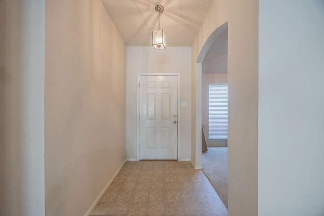 hallway featuring a textured ceiling