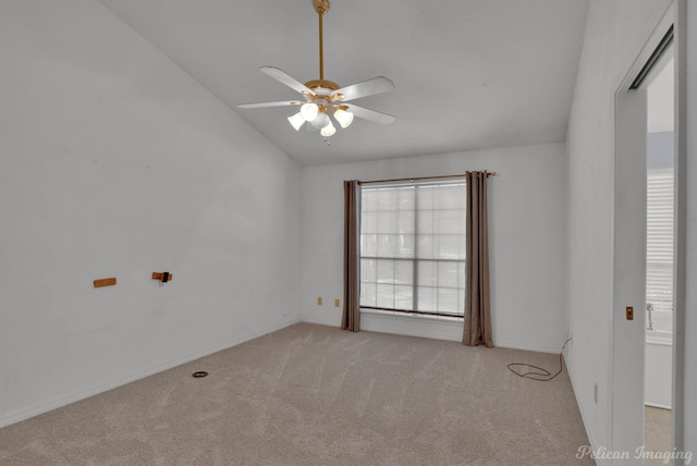 empty room featuring vaulted ceiling, light carpet, and ceiling fan