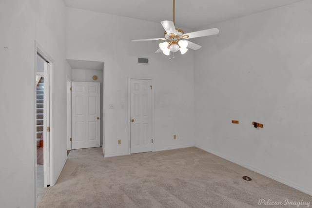 empty room featuring light carpet and ceiling fan