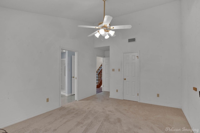 carpeted spare room with ceiling fan