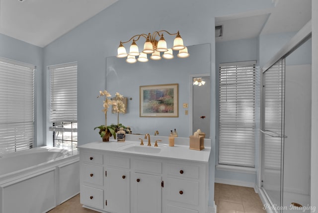 bathroom with vaulted ceiling, vanity, tile patterned flooring, and a tub