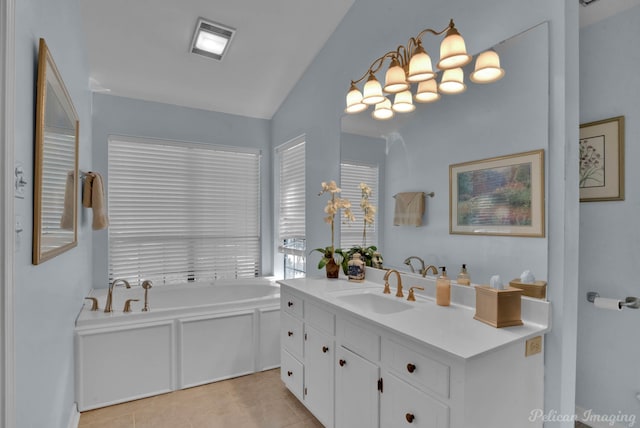 bathroom featuring vanity, a bath, tile patterned flooring, and lofted ceiling