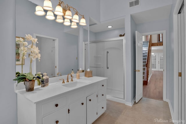 bathroom featuring vanity, tile patterned floors, and walk in shower