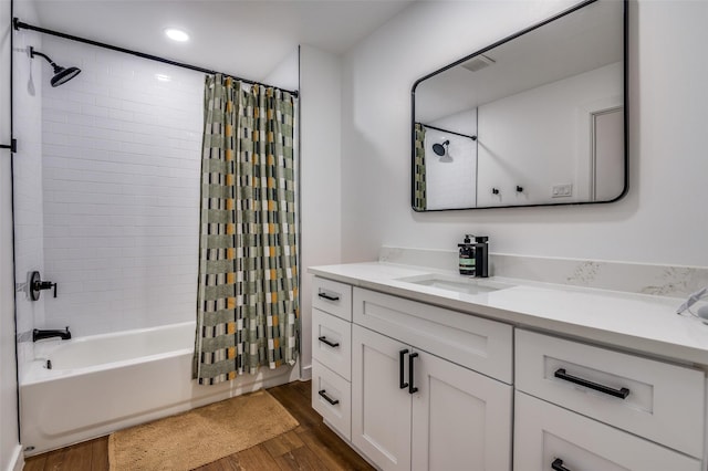 bathroom featuring vanity, wood-type flooring, and shower / tub combo with curtain