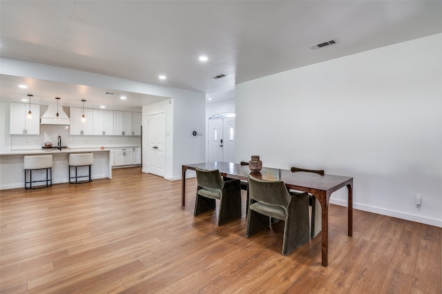 dining room featuring light hardwood / wood-style flooring and sink