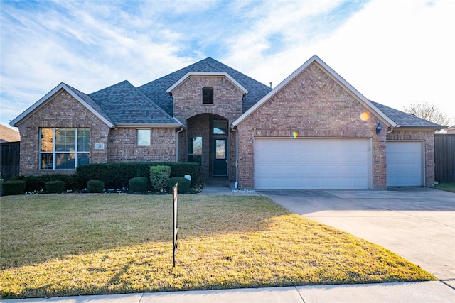 view of front of home featuring a garage and a front lawn