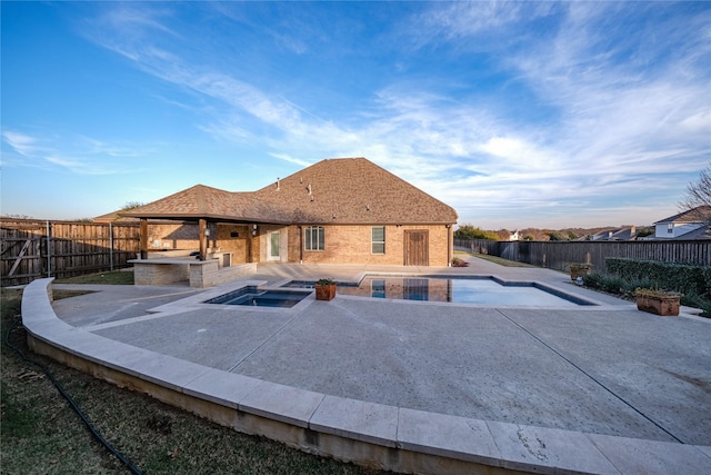 view of pool with an in ground hot tub, a fenced in pool, a fenced backyard, and a patio area