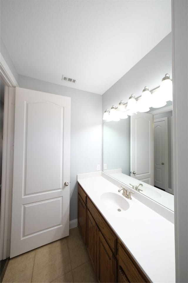 bathroom with tile patterned floors, visible vents, and vanity