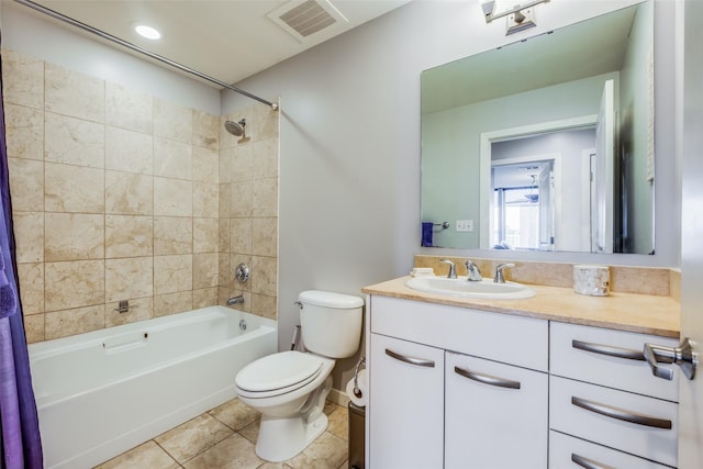 full bathroom with toilet, vanity, tiled shower / bath combo, and tile patterned flooring