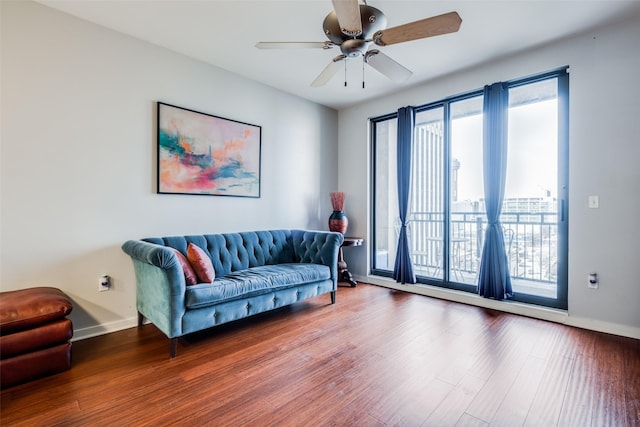 living area featuring wood-type flooring and ceiling fan