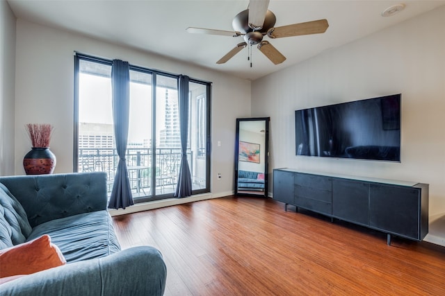 living room featuring hardwood / wood-style flooring and ceiling fan