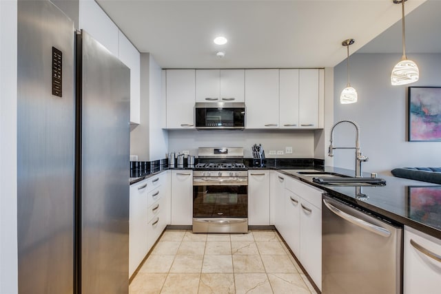 kitchen with hanging light fixtures, white cabinetry, sink, and appliances with stainless steel finishes