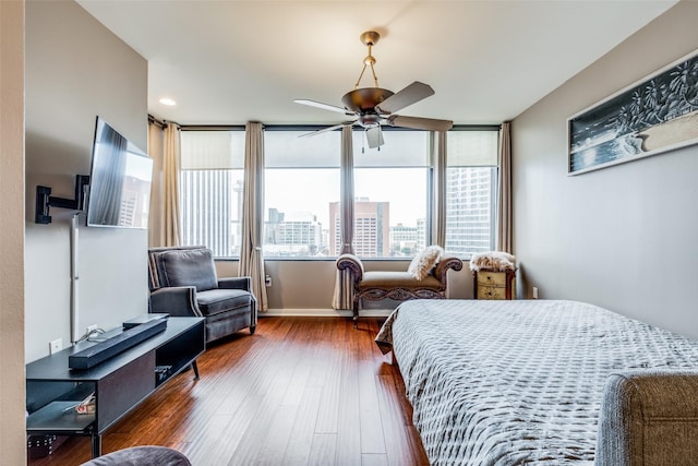 bedroom featuring dark hardwood / wood-style flooring and ceiling fan