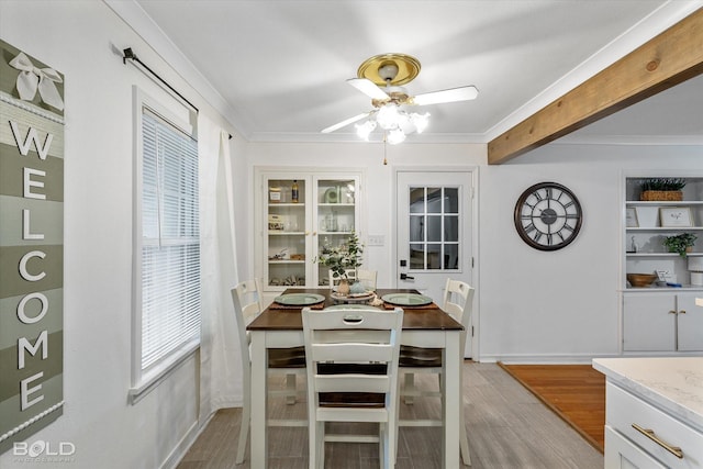 dining area with ceiling fan, light hardwood / wood-style floors, and ornamental molding