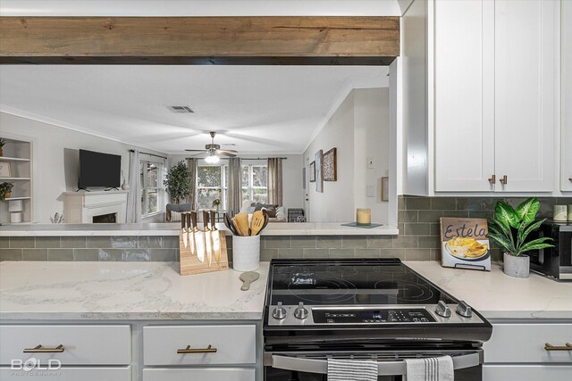 kitchen featuring white cabinetry, crown molding, electric range, ceiling fan, and decorative backsplash