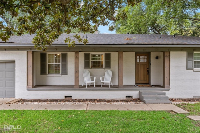 view of front facade featuring covered porch and a garage