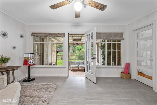 entryway featuring french doors, ceiling fan, and ornamental molding